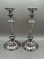 Pair of large silver plated antique candlesticks showing full height and base detail