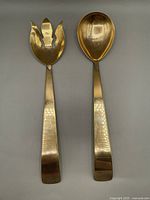 Full view of salad fork and spoon showing gold wash finish and flat handles with hammered texture