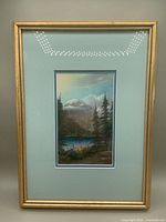 Framed pastel of Lake Louise with gold wood frame and aqua mats