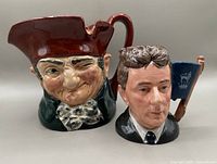 Photo showing two Royal Doulton Toby jugs side by side, depicting old man and young man characters