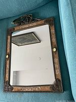 Full view of rectangular mirror showing the reflective surface and decorative frame