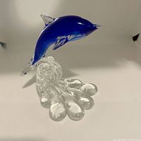 Blue dolphin art glass figurine side view showing base and leaping pose