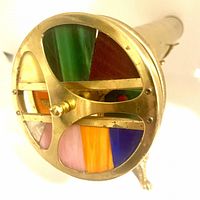 Close-up of viewing end showing colored stained glass sections and brass frame.