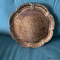 Front of gold gilt Florentine Italian wood tray showing ornate Arabic floral carvings and scalloped edges
