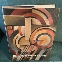 Front cover of hardcover art book with dust jacket showing abstract geometric artwork and title text