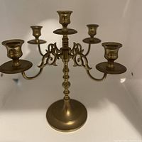 Front view of the solid brass 5-arm candelabra candle holder showing all five arms and the base.