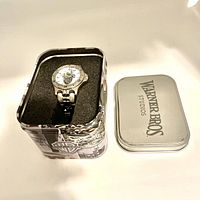 Wristwatch in original Warner Bros tin box with lid off