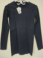 Front view of the black women's sweater showing long sleeves and crew neckline with original tags attached on hanger.