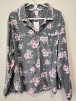 Front view of the grey floral button-up top with white lace trim on collar, pocket, and cuffs.