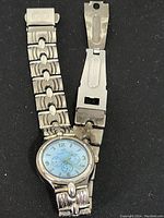 Full view of Christian Dior women's wristwatch with broken silver-toned linked metal band showing damage near clasp.