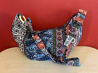 Side view of the bohemian paisley crossbody bag showing fabric pattern and strap