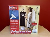 Front of original box showing garment steamer with a woman steaming a dress, highlighting features like 45-second quick heat-up, safe for all fabrics, and auto shut-off.