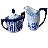 Photo showing the blue and white lidded sugar bowl and creamer with floral and geometric patterns