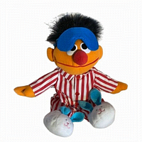 Front view of the plush Ernie in red and white striped pajamas with blue sleep mask and white bunny slippers.
