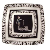 Photo showing the two square ceramic platters nested, decorated with a vintage Art Deco styled woman holding a chain leash attached to a reclining black and white striped tiger, with black and white tiger stripe patterned borders.