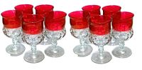 Group of 10 vintage thumbprint glasses with ruby flashed rims in two rows.