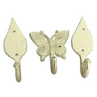 Set of three white wrought iron wall hooks including 1 butterfly-shaped and 2 leaf-shaped hooks.