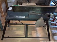 Front view of Rockwell Beaver joiner showing long 35x6 inch deck and metal stand.