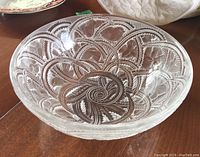 Angled top view displaying frosted and clear swirling bird and leaf motif