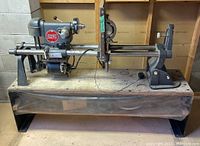 Side view showing lathe and wood turning setup with motor and tool rest.