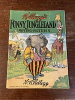 Front cover of the book displaying an illustrated elephant in a suit and a giraffe, along with 'Kellogg's Funny Jungleland Moving Pictures' title.