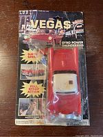 Front view of original blister packaging showing 1978 Vegas Gyro Power Thunderbird toy car with red body and white roof. Packaging shows significant creases and damage.