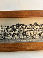 Close-up of group of people from the reunion photo showing detail of individuals and caption text.