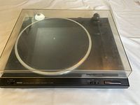Yamaha TT-230 turntable with dust cover closed, black body, metal platter visible