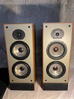 Front view of both Paradigm speakers showing twin woofers, tweeter and cabinet finish