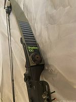 Close-up of the limb of the bow showing the 'Shadow 100' branding and detailing on the grip area.