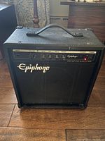 Front view of vintage Epiphone bass amplifier EP 800B showing logo and control panel with knobs and power light on.