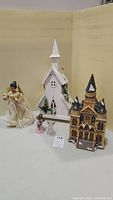 Group photo of wood church, ceramic church, and angel figurines for Christmas decoration lot