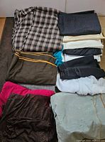 Box of various folded fabrics in different colors and patterns seen from above.