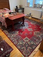 General view of full rug under bed and bench in room