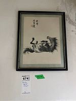 Full front view of framed horse print hanging on wall
