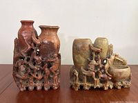 Front view of both hand carved Chinese soapstone vases showing the detailed bird and floral openwork carvings and natural stone coloration.