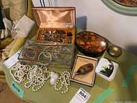 Overview of all items including jewelry box, trinket boxes, faux pearl necklace and brooch