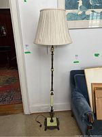 Full view of floor lamp with fabric shade, showing entire lamp height and surroundings.