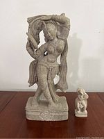 Front view of both Hindu stone statues, larger (12 inch) on left, smaller (3.5 inch) on right