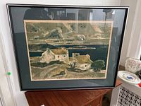 Full view of the framed and matted original lithograph showing the landscape scene of two rustic houses near water and hills.