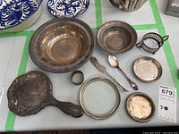 Overview of lot: bowls, dishes, flatware, mirror, glass dish with rim, napkin ring