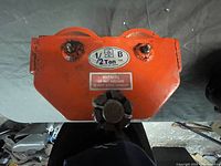 Top-down view showing the front of the beam trolley with capacity label and warning.