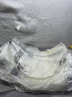 Clear Fibre-Metal 4199CL hard hat face shield shown wrapped in protective plastic with visible branding on the plastic packaging.