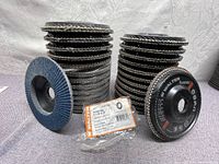 Multiple stacks of new Walter Flexsteel abrasive flap discs, showing the layered flap design and packaging label.