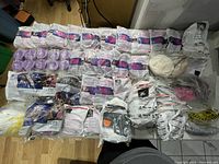 Full lot overview on table showing multiple sealed filter pouches, loose filters, respirator accessories.