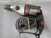 Side view of Metabo SBE 750 hammer drill showing green and red housing and power cord.