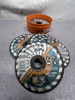 Top view of several Walter ZIP+ cutoff wheels showing branding, size and usage information.
