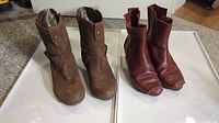 Both pairs of boots side by side showing maroon and brown leather boots