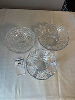 Top-down view of 3 bowls showing detailed patterns on crystal and glass bowls.