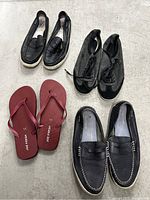 Four pairs of men's shoes on floor: black Lacoste sneakers, black slip-on loafers, black lace-ups, red Joe Fresh flip-flops.